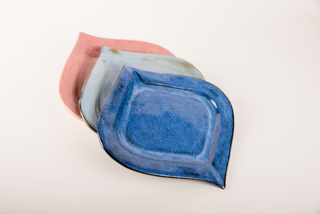 שלוש צלחות מקרמיקה בצבעים שונים בצורת עין